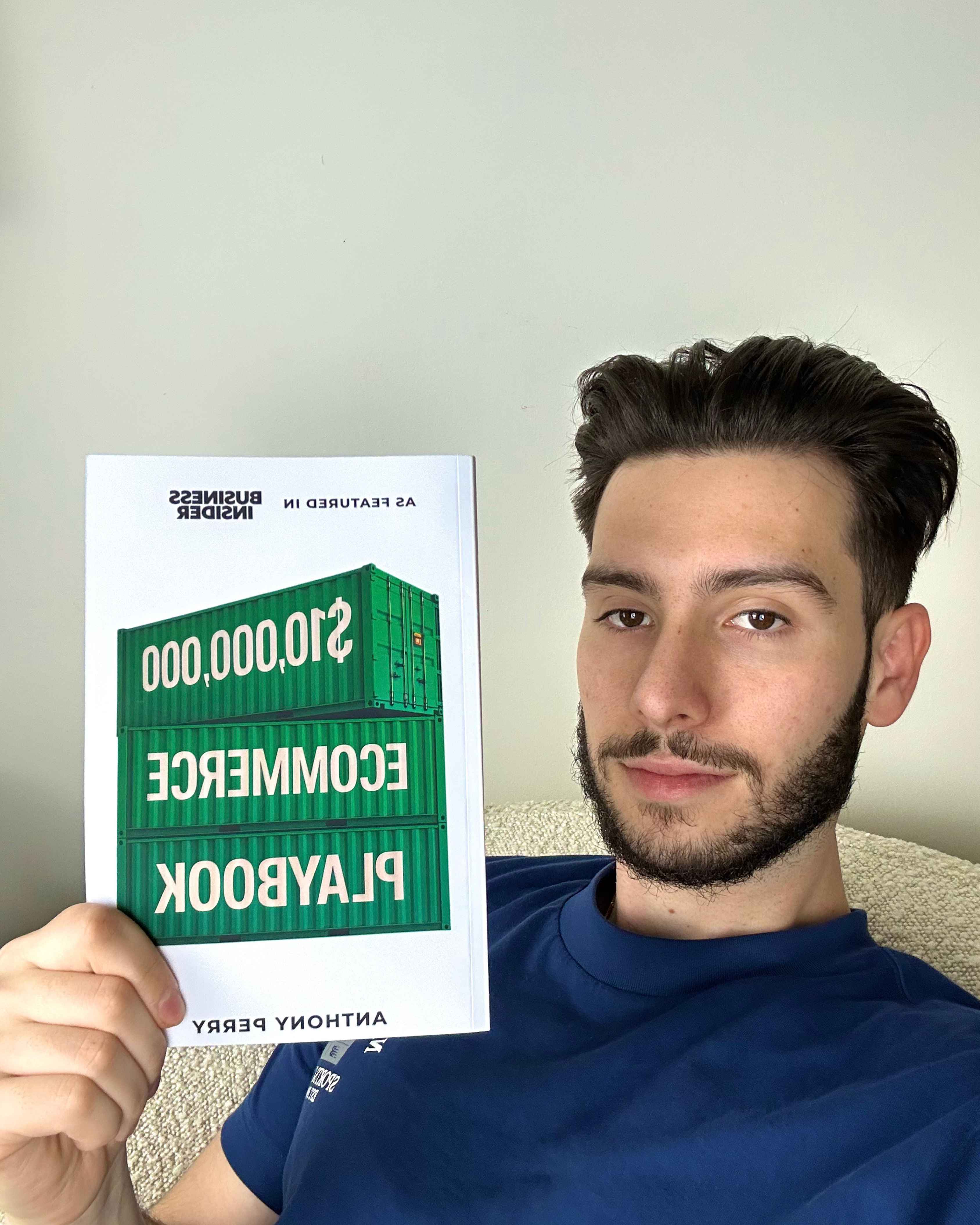 Anthony Perry holding the $10,000,000 Ecommerce Playbook